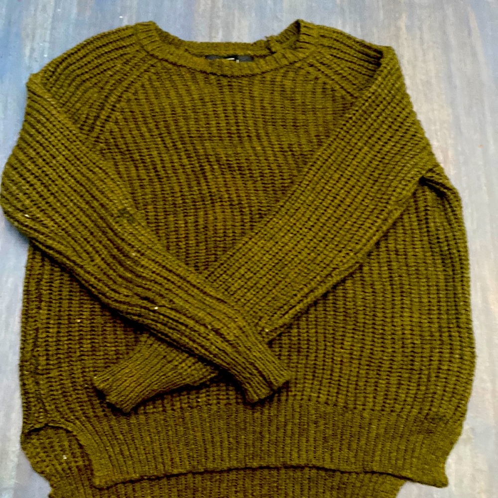 *this sweater has a few stains, one on the arm and another on the torso part*